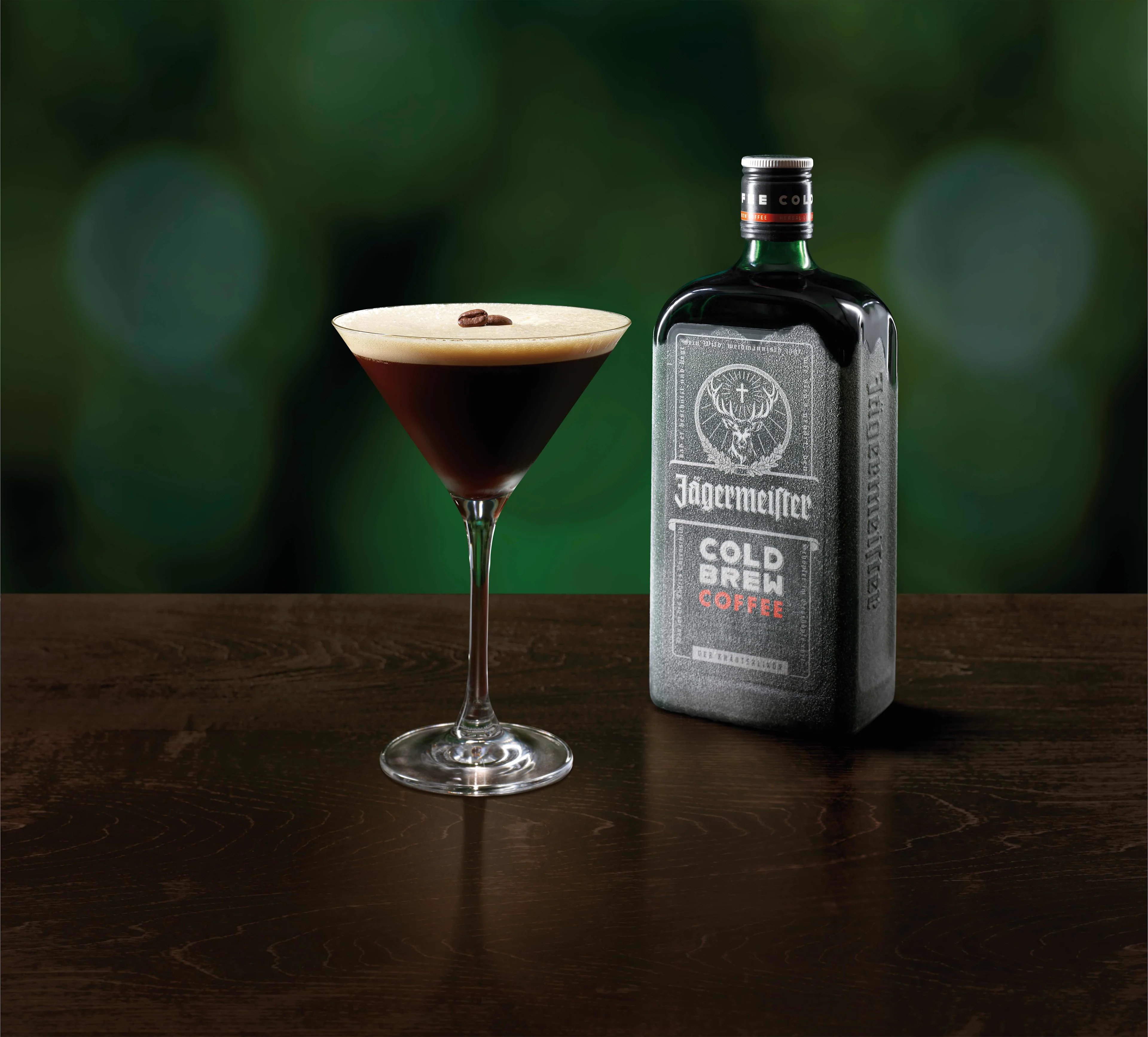 A glass of CBC Espresso Martini in front of a Jägermeister CBC bottle