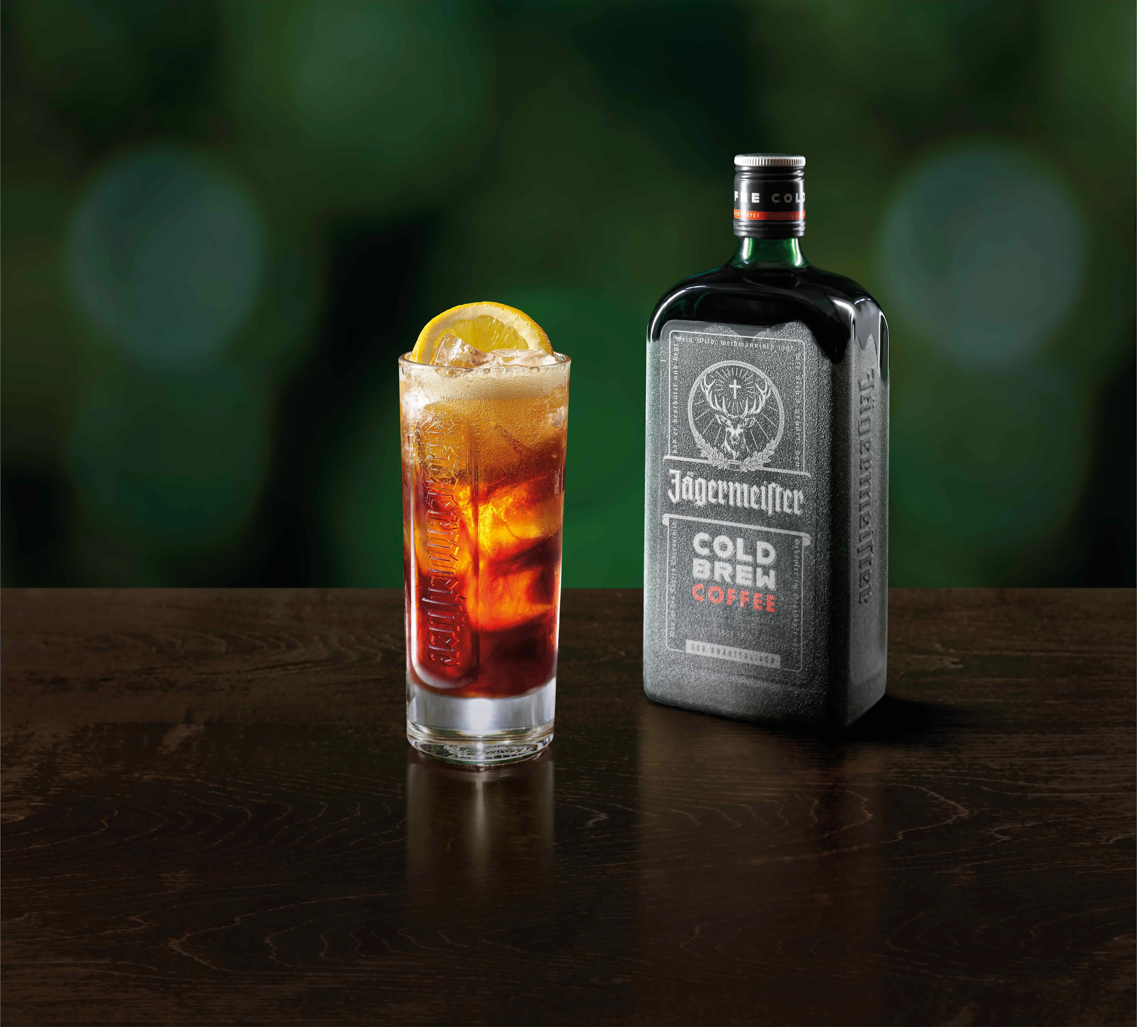 A glass of CBC tonic in front of a Jägermeister CBC bottle